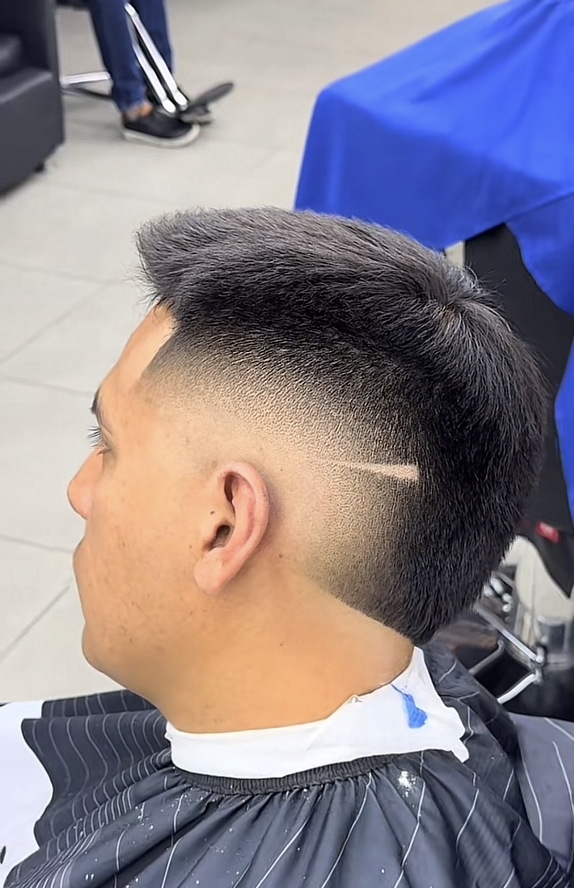 Sharp skin fade with a clean part, finished at Kingly Cutz Barbershop