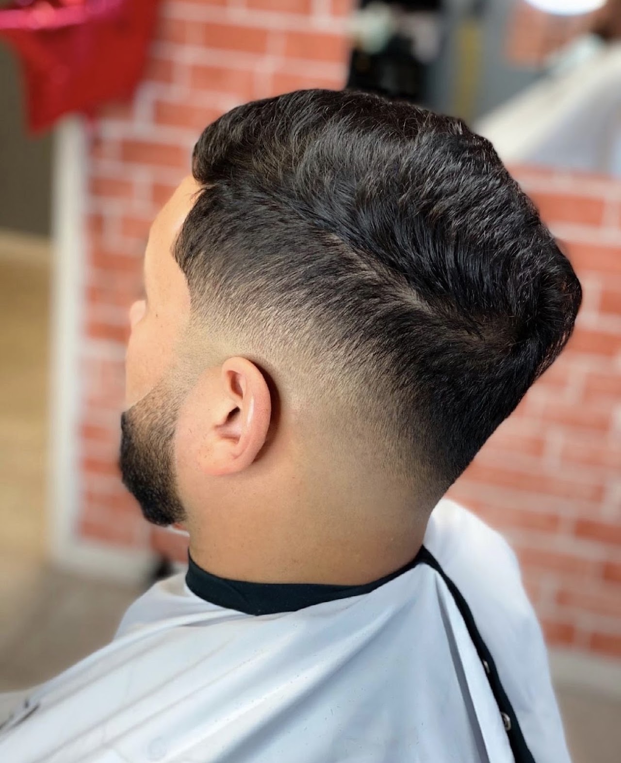 Classic pompadour fade with a full beard, finished at Kingly Cutz Barbershop